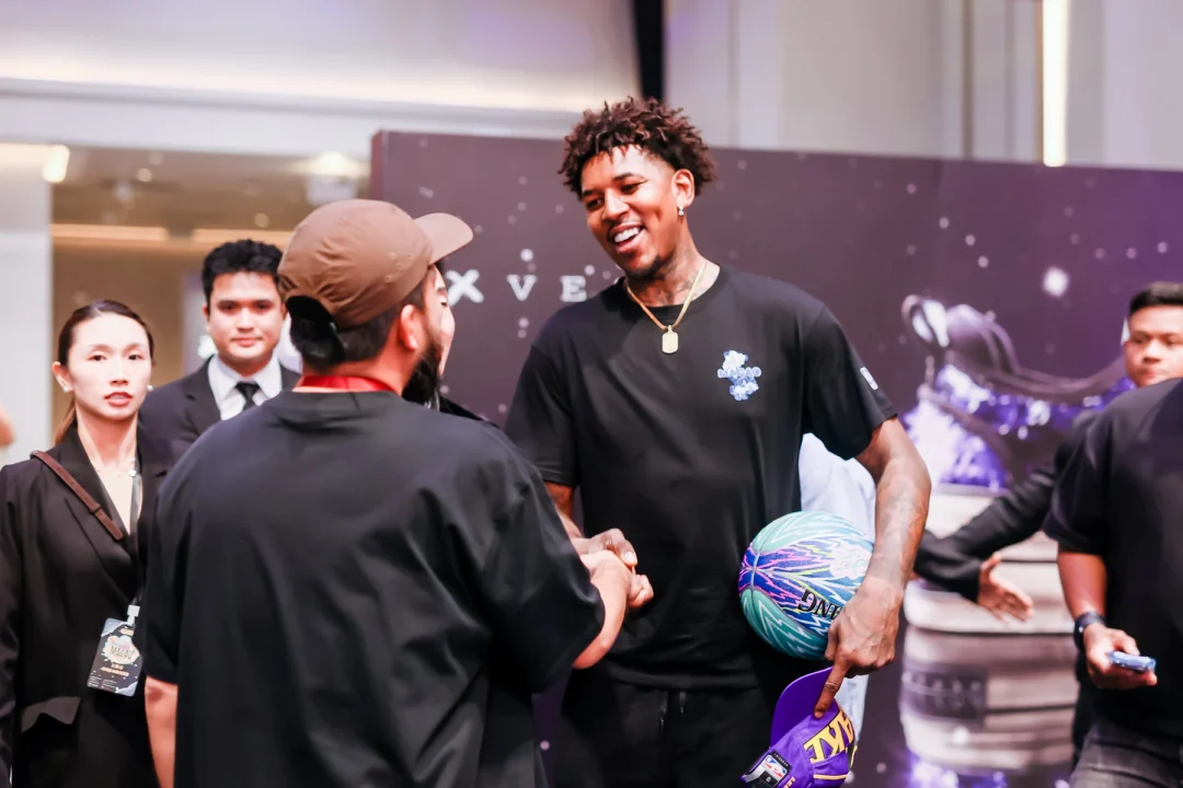 A guest greeting during Sneaker Con Macau with the on-site team nearby.